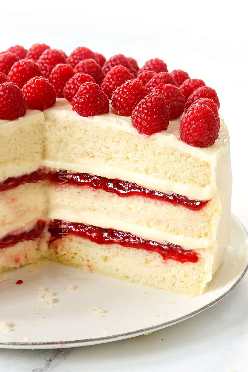 White Cake with Raspberry Filling and White Chocolate Cream Cheese Frosting